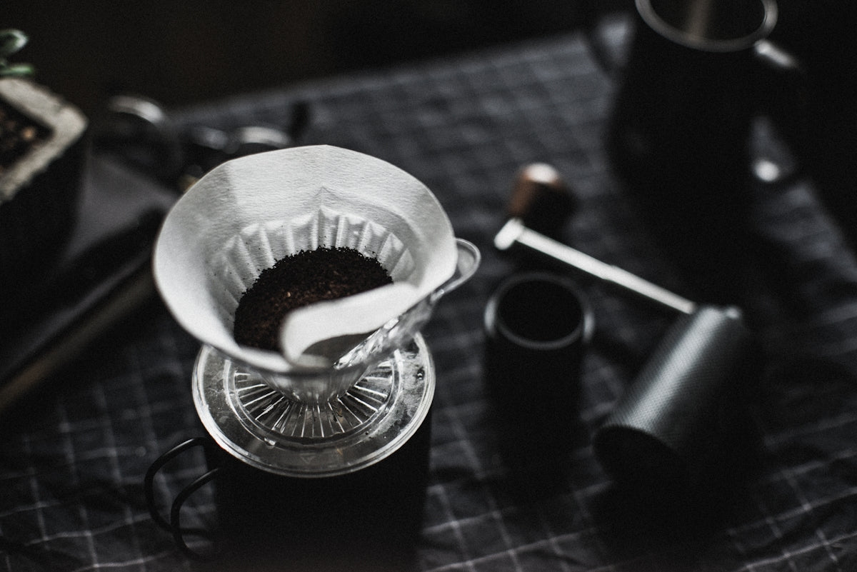 clear glass cup with black liquid