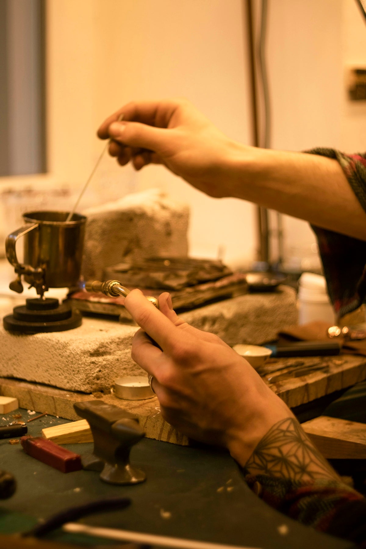 person pouring water on silver cup