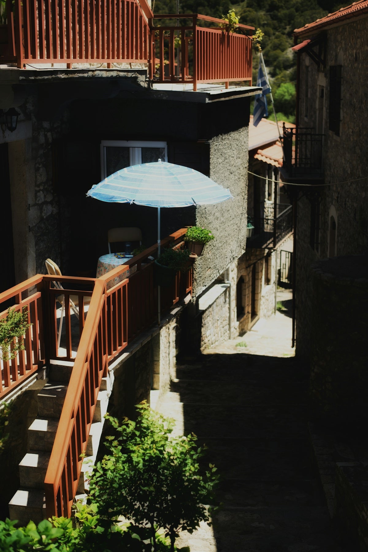 a blue umbrella sitting on the side of a building