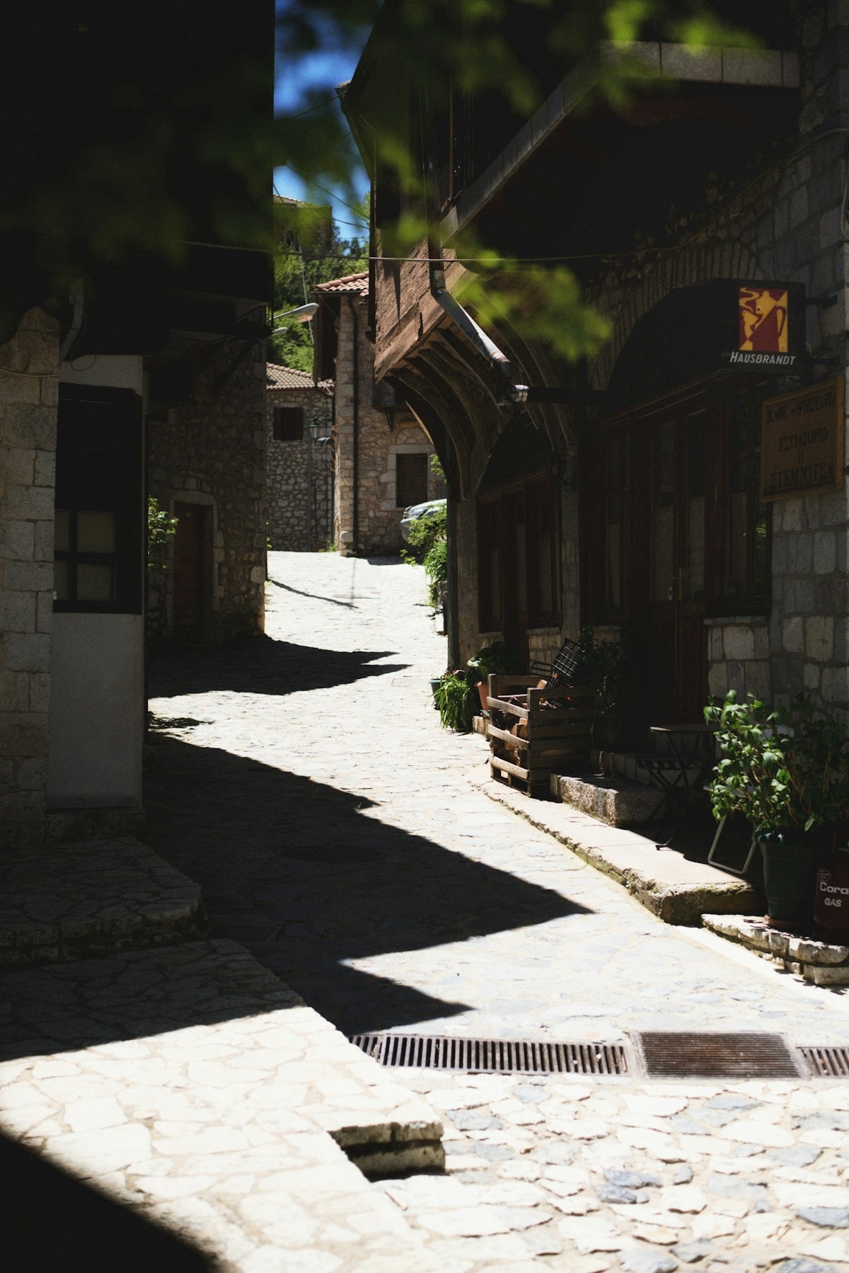 a narrow cobblestone street lined with stone buildings