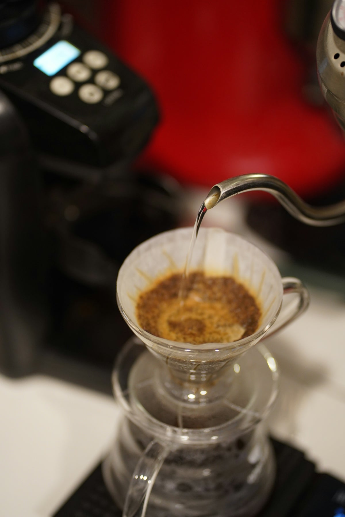 a person pours a cup of coffee into a coffee maker