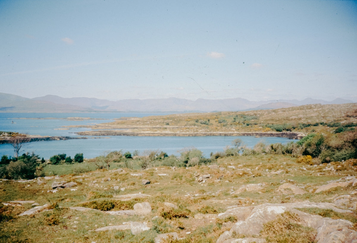 A scenic landscape with water and hills.