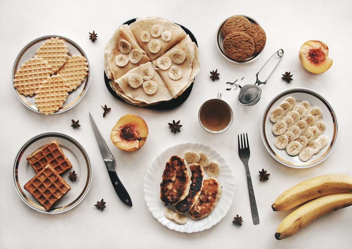 A delicious breakfast spread with pancakes, waffles, and fruit.