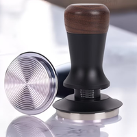 Thumbnail for Coffee tamp with wooden top and metal base on a reflective surface