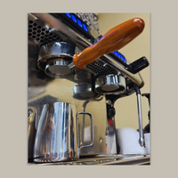 Thumbnail for Close-up of an espresso machine with a wooden handle on a beige background