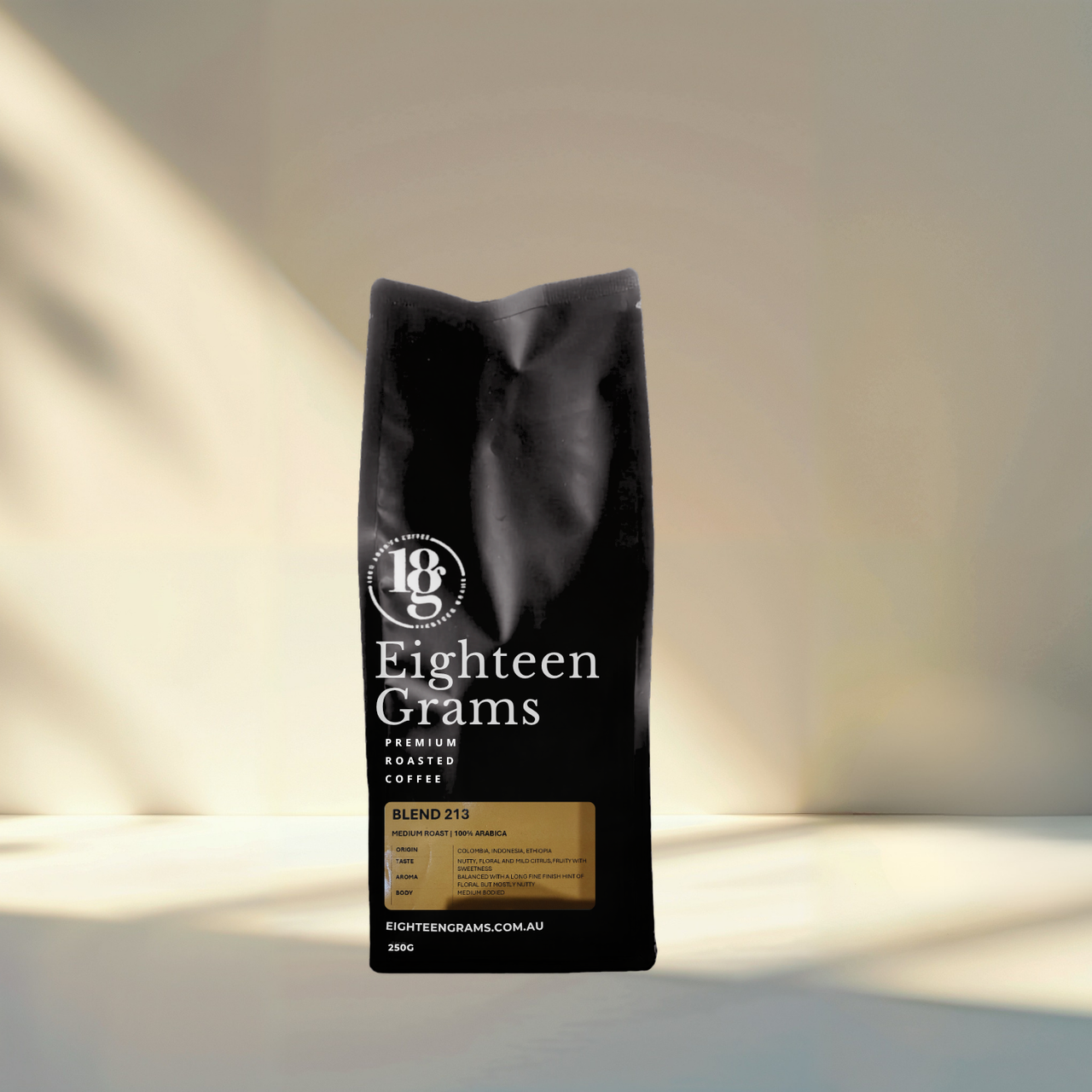 Black coffee bag labeled 'Eighteen Grams' on a light background. 250G blend 213.