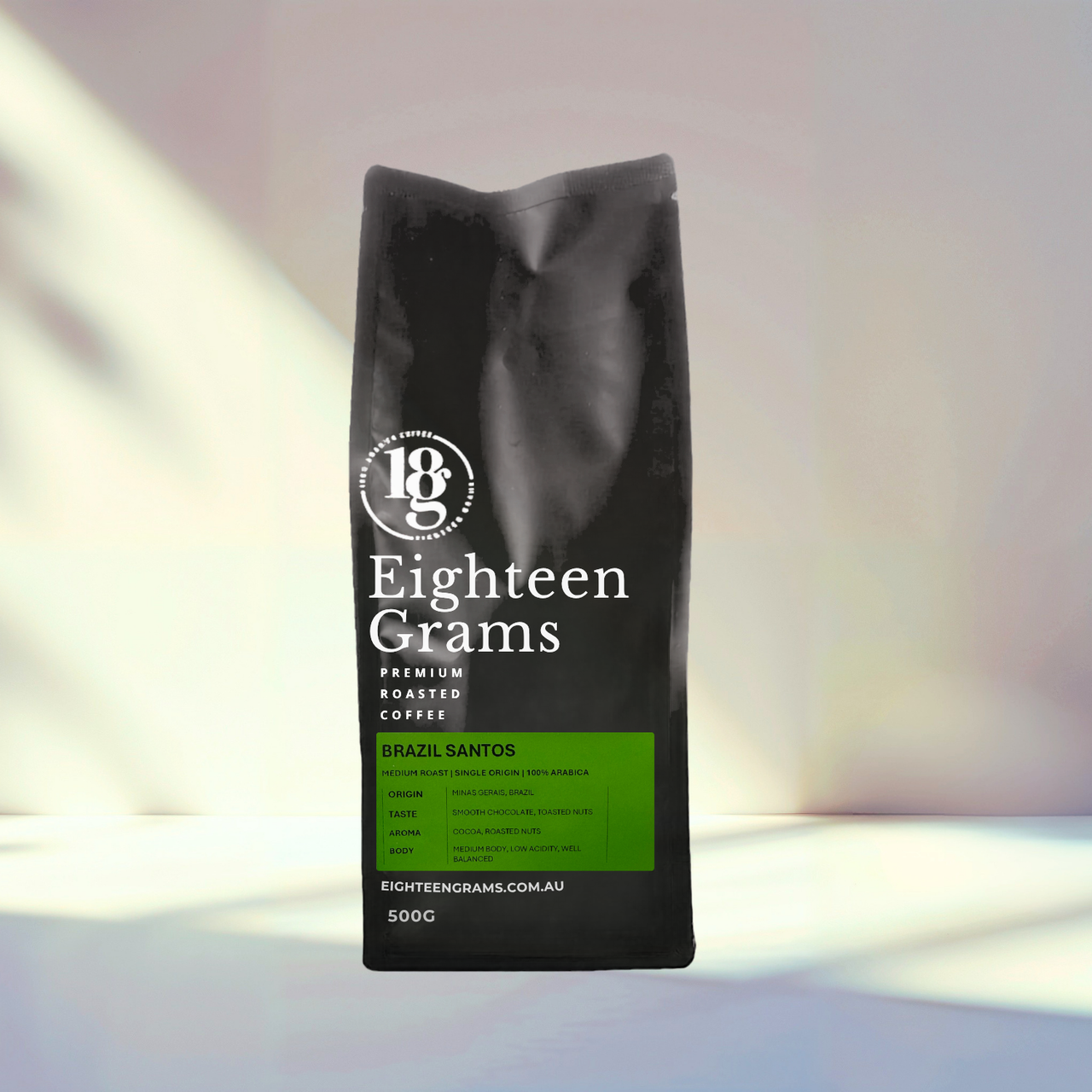 Black coffee bag labeled 'Eighteen Grams' on a light background