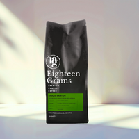Thumbnail for Black coffee bag labeled 'Eighteen Grams' on a light background