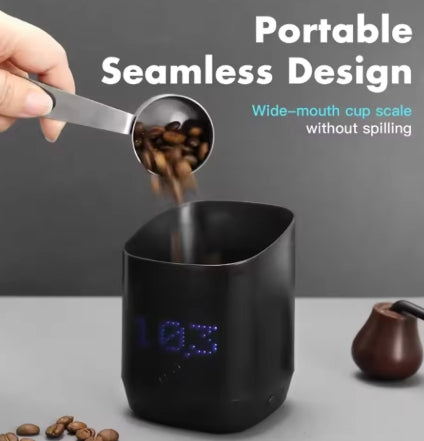 Black digital cup scale with coffee beans being poured into it, featuring text about its design.