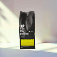 Thumbnail for Coffee bag labeled 'Eighteen Grams' on a soft focus background