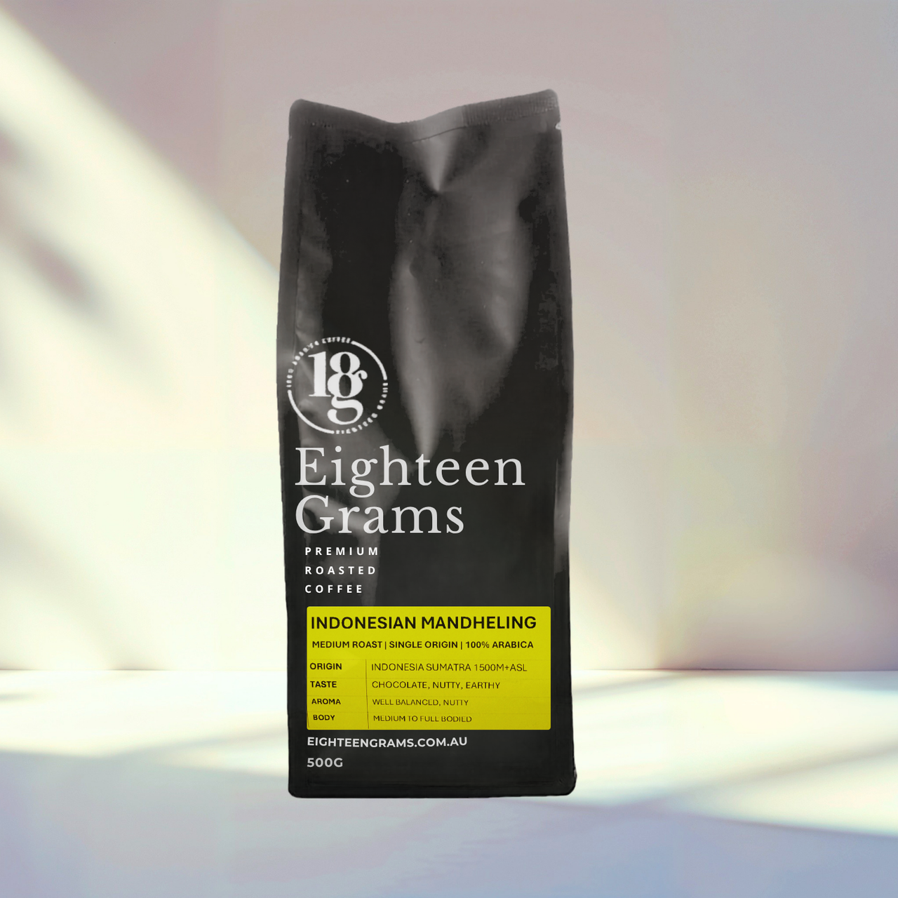 Black coffee bag labeled 'Eighteen Grams' on a gradient background