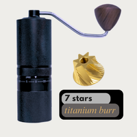 Thumbnail for Black coffee grinder with wooden handle and gold burr on a light gray background