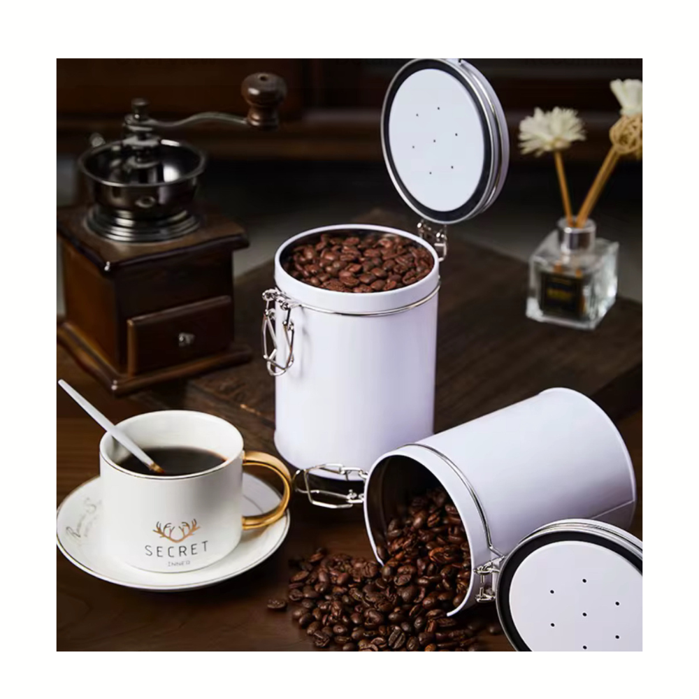 White canister with coffee beans next to a cup of coffee on a wooden table.