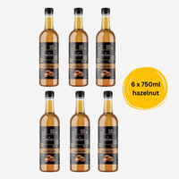 Thumbnail for Six bottles of hazelnut syrup with a yellow label indicating 6 x 750ml size on a white background.