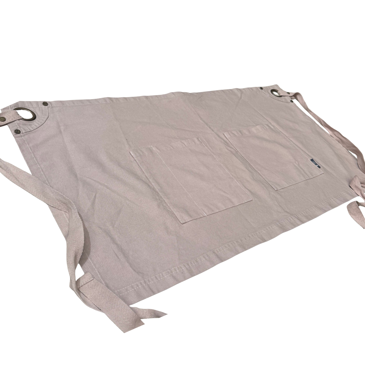 Beige apron with multiple pockets on a white background