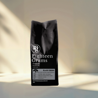 Thumbnail for Black coffee bag labeled 'Eighteen Grams' on a neutral background. A bold dark roast coffee blend featuring Colombian, Brazilian, Papua New Guinean and Robusta beans, ideal for espresso, stovetop and milk-based coffees.