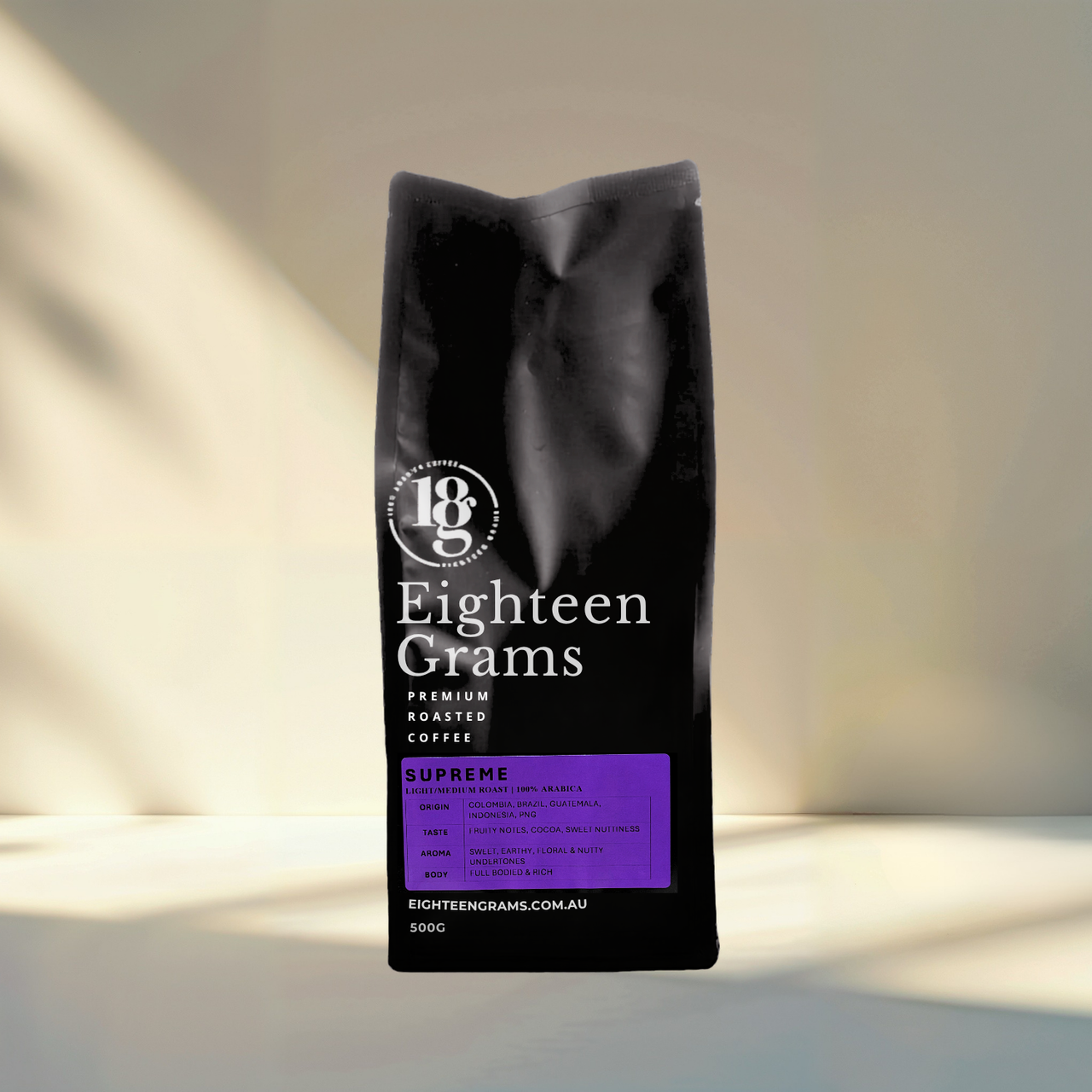 Black coffee bag labeled 'Eighteen Grams' on a light background.blend-supreme-100-percent-arabica-coffee-beans