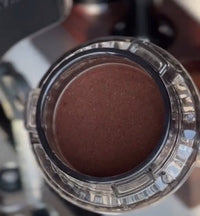 Thumbnail for Close-up of a coffee filter with a brown substance inside, likely coffee grounds.