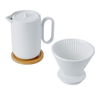 Thumbnail for White ceramic teapot with lid and wooden coaster, and a white ceramic tea filter on a white background.