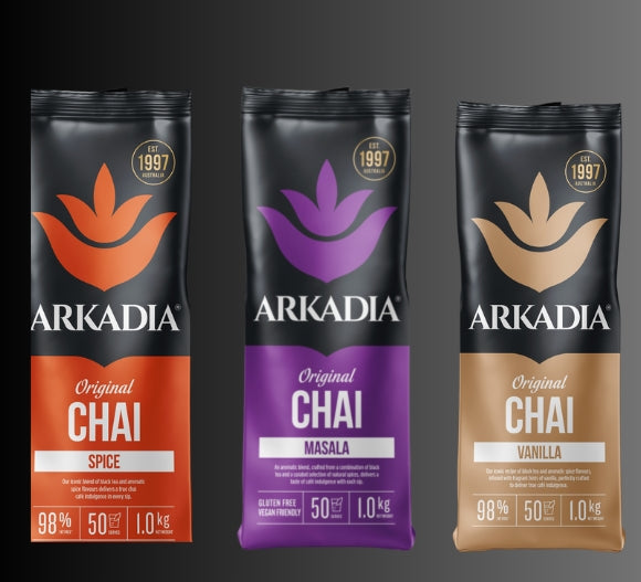 Three packages of Arkadia Chai on a dark background