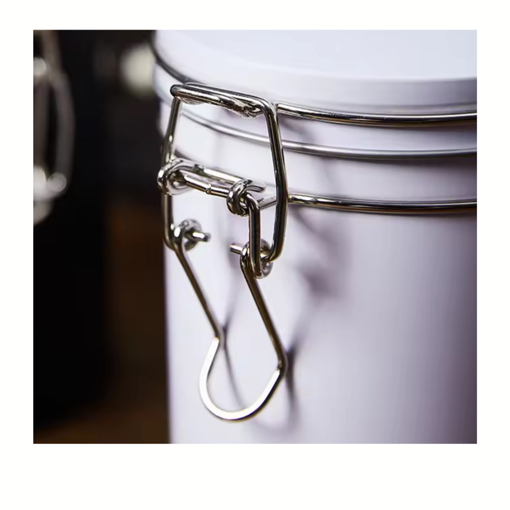 Close-up of a metal clasp on a white container with a blurred background
