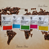 Thumbnail for Five 'Eighteen Grams' coffee packages with different flavor labels on a brown background with coffee beans.