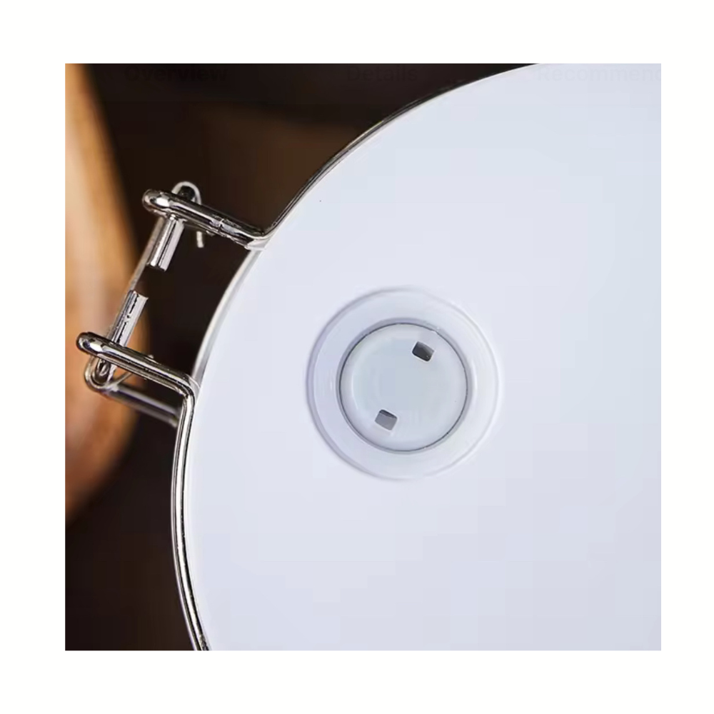 Close-up of a white socket on a white surface with a dark background
