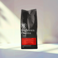 Thumbnail for Black coffee bag labeled 'Eighteen Grams' on a light background