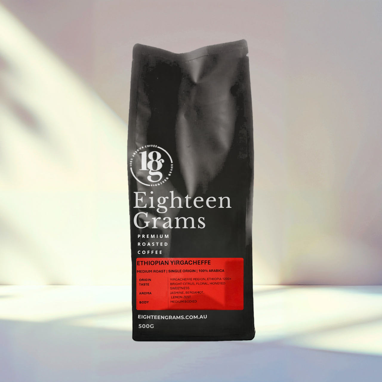 Black coffee bag labeled 'Eighteen Grams' on a light background