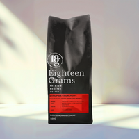 Thumbnail for Black coffee bag labeled 'Eighteen Grams' on a light background