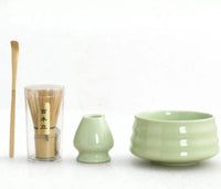 Thumbnail for Tea-making set with green ceramic bowls and a glass container on a white background