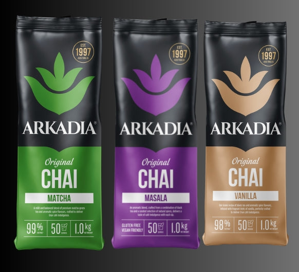 Three packages of Arkadia Chai on a dark background