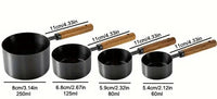 Thumbnail for Set of black measuring cups with wooden handles and measurements on a white background