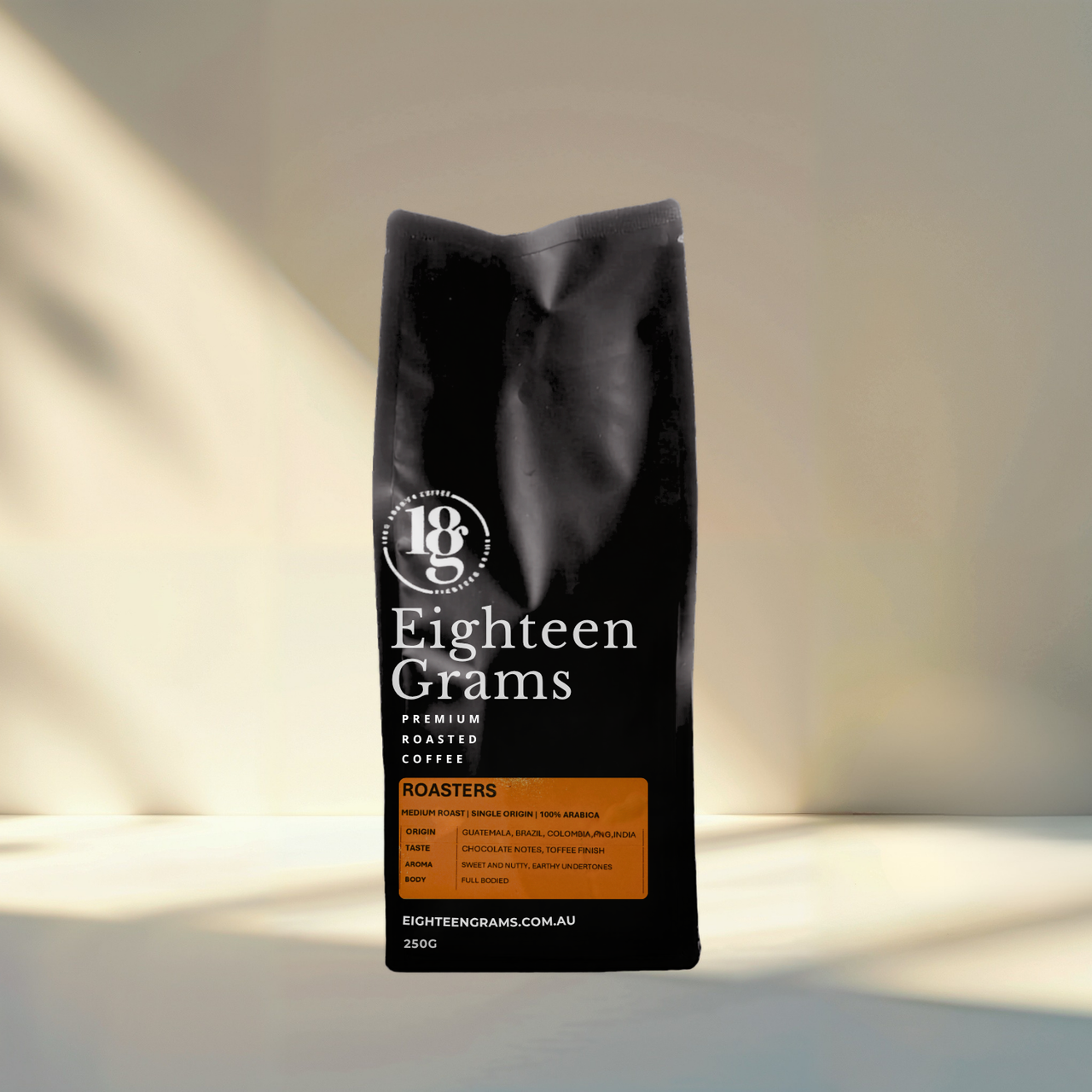Black coffee bag with 'Eighteen Grams' branding on a neutral background. Roasters Blend – Medium Roast Coffee Beans – 250g