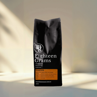 Thumbnail for Black coffee bag with 'Eighteen Grams' branding on a neutral background. Roasters Blend – Medium Roast Coffee Beans – 250g