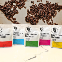 Thumbnail for Coffee bean packages labeled 'Eighteen Grams' arranged on a world map background.