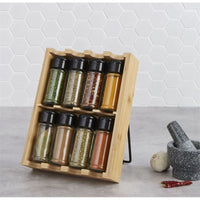 Thumbnail for Wooden spice rack with black lids containing various spices on a kitchen counter.