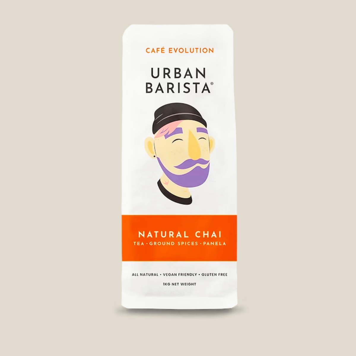 A package of Urban Barista Natural Chai tea, featuring a white bag with a stylized illustration of a man's face and a prominent orange band at the bottom.