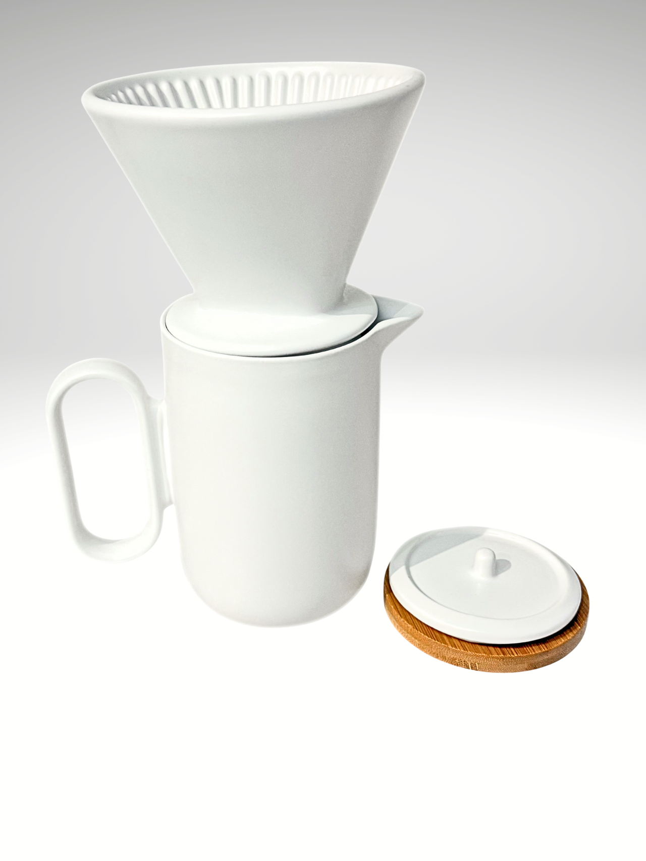 White ceramic coffee maker with a wooden lid on a white background